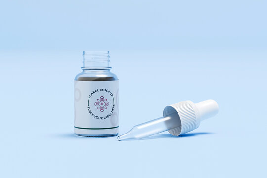 Glass dropper bottle with pipette on blue background