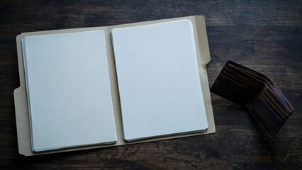 Fototapeta premium Open Blank Photo Album with Wallet on Wooden Table.