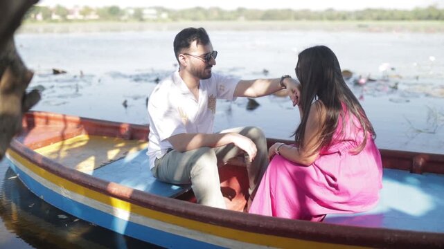 Romantic Couple Enjoying a Boat Ride on a Peaceful Lake During Daytime