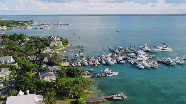 Aerial view of the marina with luxury yachts docked at the waterfront in Dunmore Town, Harbour Island, The Bahamas.