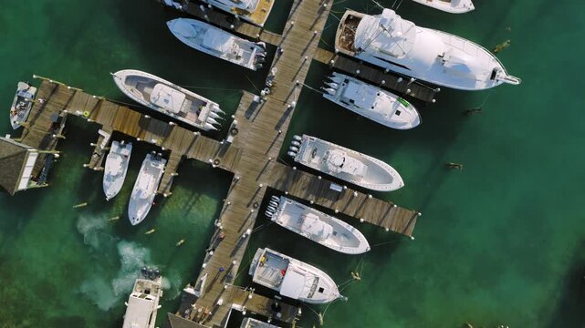 Aerial view of boats docked at a marina with turquoise water in Dunmore Town, Harbour Island, The Bahamas.
