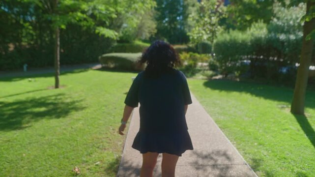 A Serene Walk Through a Lush Garden Pathway as the Sun Shines Brightly, Emphasizing the Tranquility and Natural Beauty of the Outdoors