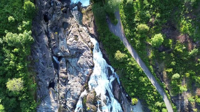 Drone Tilt Revealing Hellesyltfossen Waterfall and Village in Norway