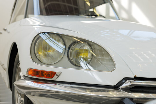 MUNICH, GERMANY - 21. April 2026: Citroen DS headlight close-up. Classic car in white color from the French manufacturer in good condition.
