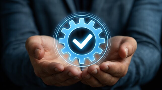 Professional hands holding a glowing digital checkmark gear symbol under bright blue illumination for quality assurance and operational efficiency in modern business workflows