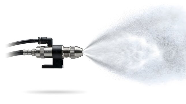 Industrial metal spray nozzle ejecting fine water mist isolated on a plain white background
