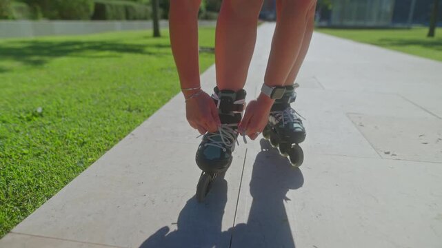 Skating Adventure: A Young Skater Ties Inline Skates Before Gliding Along the Sunlit Pathway, Enjoying Freedom and Movement in the Outdoors.