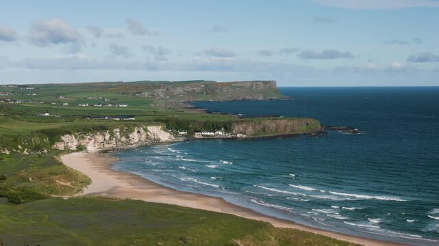 Coastline of Northern Ireland with clear water and large beaches on a sunny day, United Kingdom