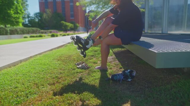 A skater prepares for adventure as they lace up their rollerblades on a sunny day, surrounded by vibrant greenery and a modern urban backdrop.