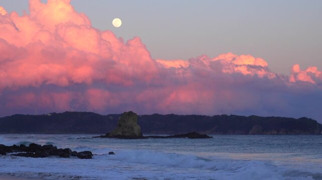 夕暮れの月と海