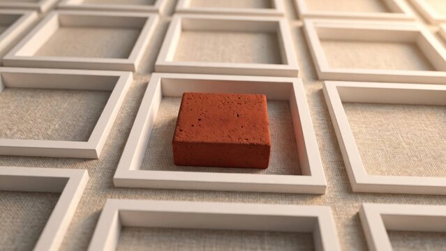 Unique Red Brick Stands Out in Grid of Empty Frames.