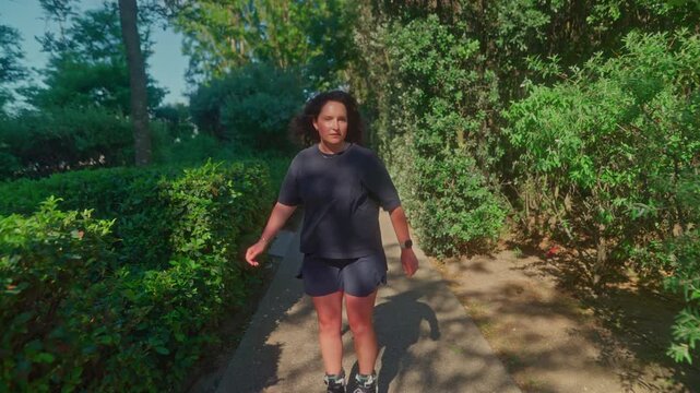 A young person enjoys a sunny day, gliding effortlessly on roller skates through a vibrant, green park, showcasing the joy of outdoor activities and freedom of movement.