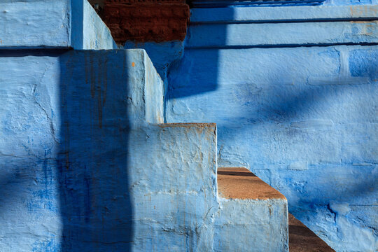 Scene featuring stairs of blue painted house in Jodhpur, aka Blue City due to the vivid blue-painted Brahmin houses around Mehrangarh Fort. Jodphur, Rajasthan