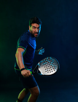Padel Tennis Player with Racket in Hand. Paddle tenis, on a blue background. Download in high resolution.