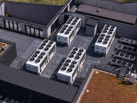 Aerial view of industrial HVAC units installed on a modern flat rooftop with green roof sections in Poland.