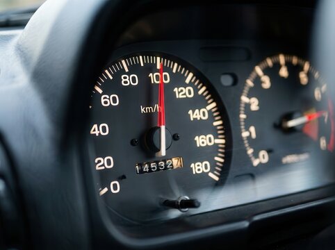 Car speedometer needle pointing to 100 km/h