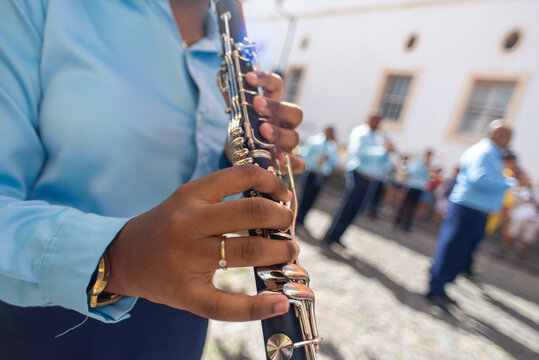 Detail of a musician playing a wind instrument at the Bahia Independence Day celebration.