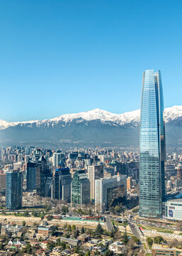 Aerial view of Gran Torre Santiago rising above the modern skyline with snow-capped Andes mountains in the background in Santiago, Santiago Metropolitan Region, Chile.