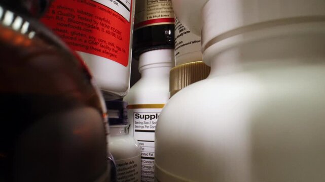 The Camera Moves Through Many Containers of Nutritional Supplements, Pills. Plastic Jars for a Complex of Vitamins and Microelements for a Healthy Diet and Longevity. Fish oil, Omega 3 or D-3 pills