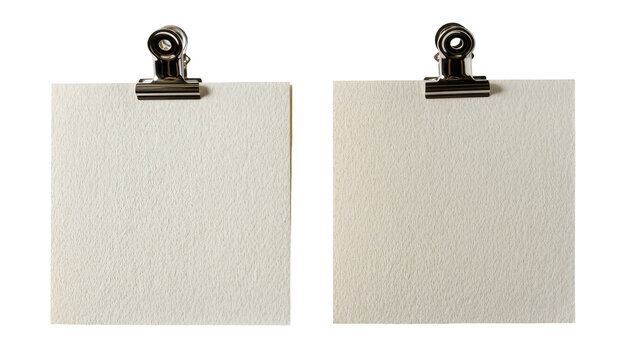 Two blank textured paper squares held by metal binder clips, isolated on transparent background