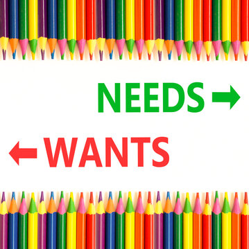 Needs instead wants words symbol. Concept words Needs Wants on beautiful white paper. Beautiful white background. Colored pencils. Business psychology needs or wants concept. Copy space.
