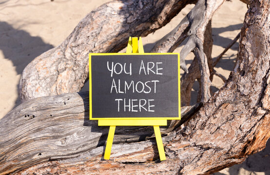 You are almost there words symbol. Concept words You are almost there on beautiful black blackboard. Beautiful tree background. Business You are almost there motivational support concept. Copy space.