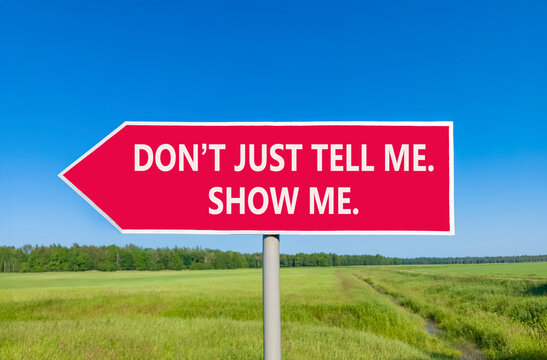 Tell or show symbol. Concept words Do not just tell me, show me beautiful red road sign. Beautiful blue sky green field background. Business tell or show concept. Copy space.