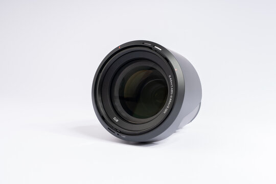 Camera lens isolated on white background. Professional photography equipment for studio work.