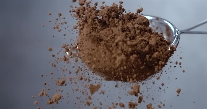 Cocoa powder falling from a sieve slow motion