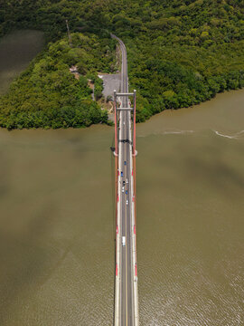 Aerial view of Puente La Amistad bridge spanning the Tempisque River, surrounded by dense tropical forest in Bagaces, Guanacaste Province, Costa Rica.