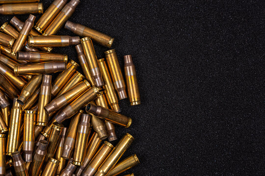 Empty brass bullet casings on black back