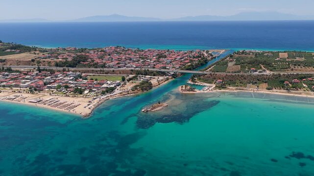 Nea Potidea coastal village along turquoise bay with a bridge