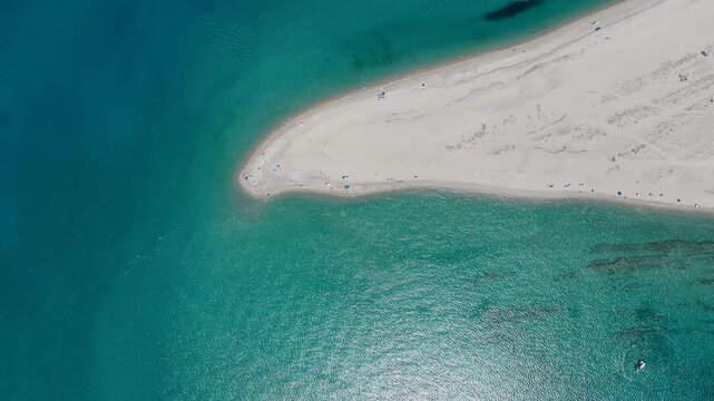 Possidi Beach from above with turquoise waters and sun umbrellas