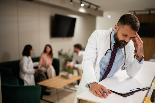Stressed doctor experiencing burnout from workload