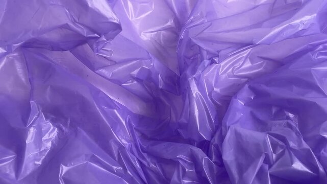 Crumpled purple plastic bag texture for pollution and recycling concept	