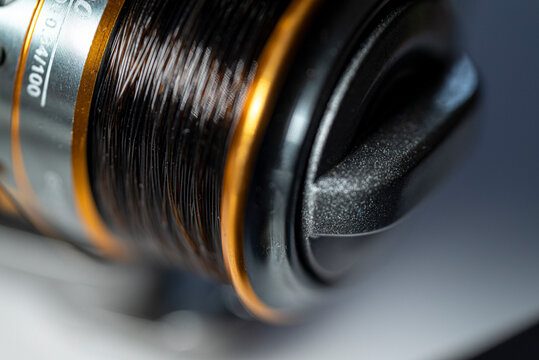 Fishing reel spool with line close up The Concept of angling gear and tech