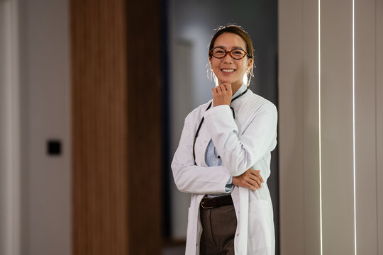 Smiling woman doctor wearing lab coat, stethoscope