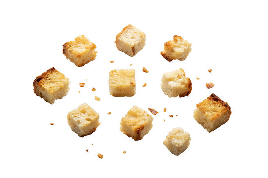 Small toasted bread croutons arranged in a circular pattern on a black background, featuring crunchy textures and golden brown crusts for cooking