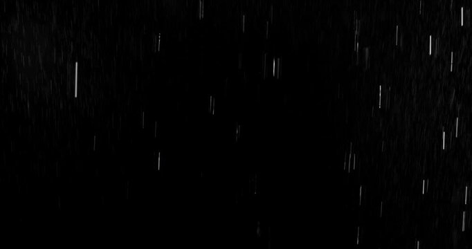 Realistic motion blurred rain streaks falling on a black background creating a natural weather VFX overlay ideal for compositing visual effects digital artwork atmospheric scenes and graphic design pr