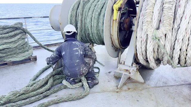 Maritime shipping industry crew preparing for docking operation.