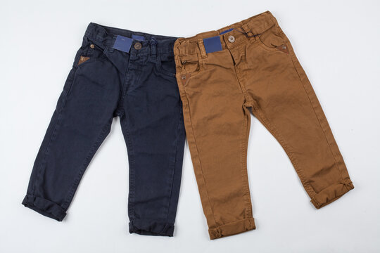Two Pairs of Kids' Cotton Trousers in Navy Blue and Brown, Stylish Boys' Casual Pants on White Background for Fashion Retail Catalog