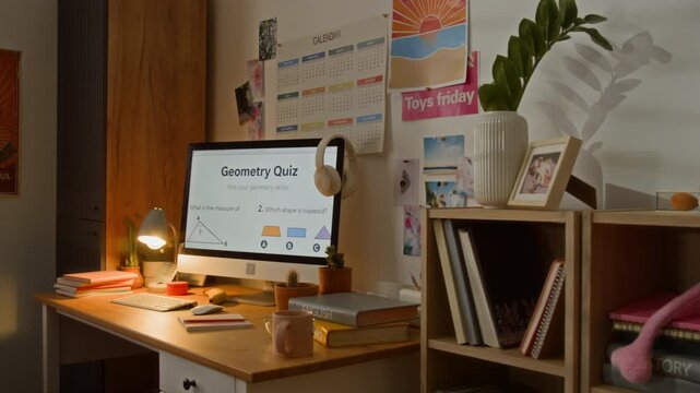 Computer monitor displaying geometry quiz sitting on organized student desk with camera zooming in. Footage ideal for promoting e-learning platforms, online tutoring services, or educational apps