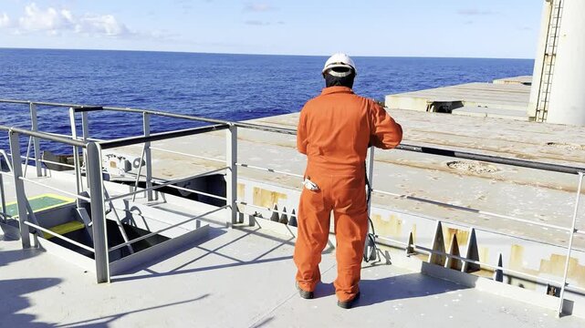 seafarer fast the rope at forecastle. vessel proceeding at sea.