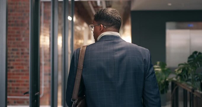 Business, walking and man with leaving, office exit and time management in workplace routine. Corporate, back and employee in agency with stroll, closing and workspace departure at end of day.