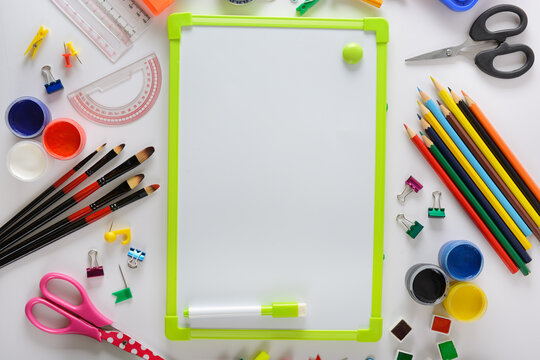 Blank Whiteboard Frame Surrounded by School Stationery Supplies Top View Flat Lay Stock Photo