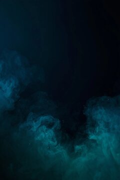 Ethereal dark Halloween vertical background with mysterious green smoke and fog effect on midnight blue backdrop with wide copy space