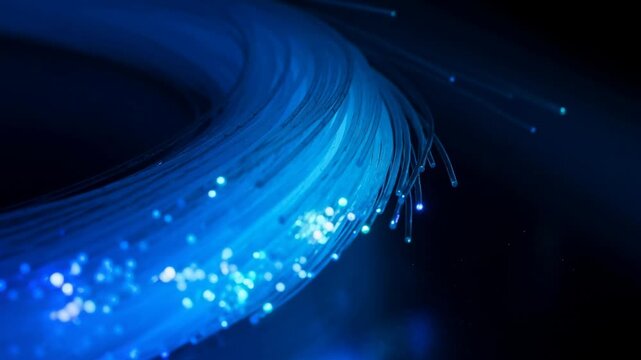 Close up of glowing blue fiber optic cables transmitting light signals in digital communication technology