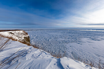 Frozen drift ice landscape of Okhotsk Sea in Hokkaido viewed from snowy cliff © kei u