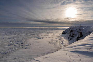 Vast sea ice drift spreading across Okhotsk Sea in winter Hokkaido with snow-covered cliffs © kei u