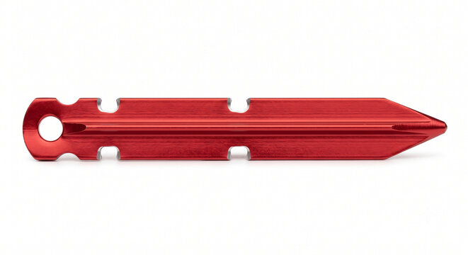 Extreme macro of a bare aluminum tent peg. Y-beam extruded metallic stake with notch cutouts, red anodized finish.